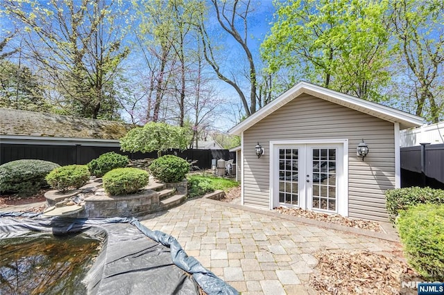 6 Colonial Ct, Dumont, NJ 07628 - exterior space featuring an outdoor structure, a fenced backyard, and a patio