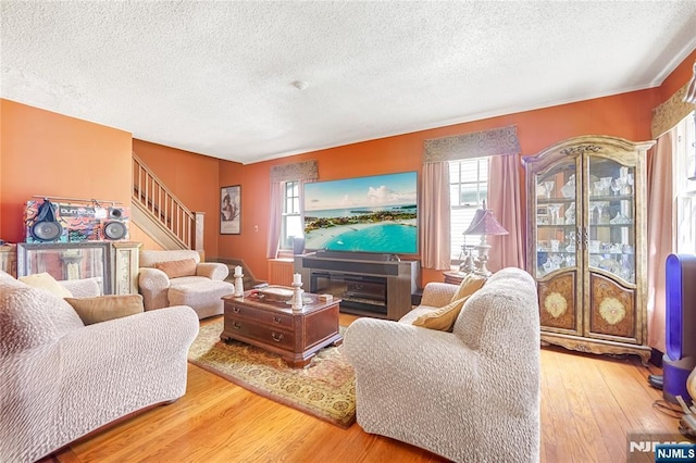 6 Colonial Ct, Dumont, NJ 07628 - living room with stairs, a textured ceiling, and wood finished floors