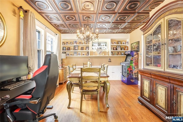 6 Colonial Ct, Dumont, NJ 07628 - dining area featuring an inviting chandelier, an ornate ceiling, light wood-style flooring, and built in shelves