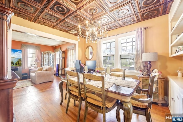 6 Colonial Ct, Dumont, NJ 07628 - dining space with an ornate ceiling, an inviting chandelier, a wealth of natural light, and hardwood / wood-style floors