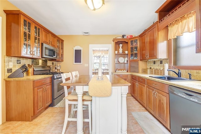 6 Colonial Ct, Dumont, NJ 07628 - kitchen featuring backsplash, stainless steel appliances, open shelves, and a sink