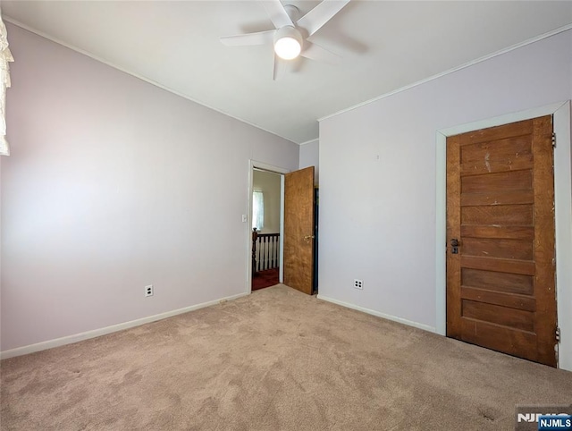 unfurnished bedroom with baseboards, carpet flooring, and ceiling fan