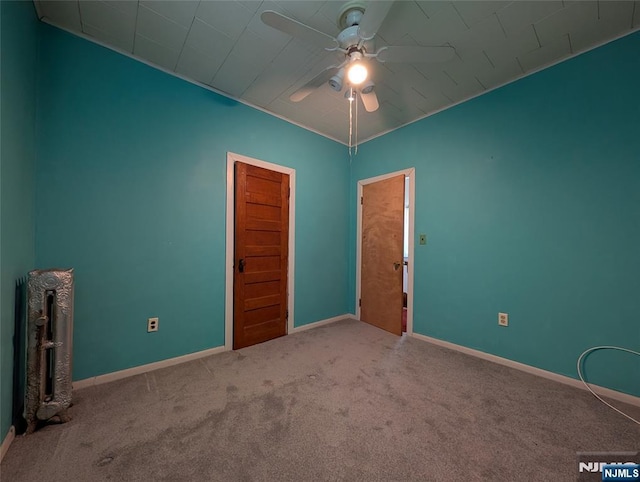unfurnished room featuring baseboards, ceiling fan, and carpet