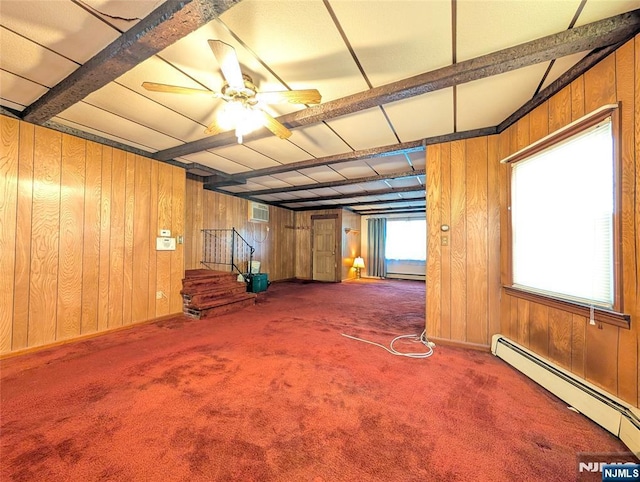 below grade area with wooden walls, carpet, and a baseboard radiator
