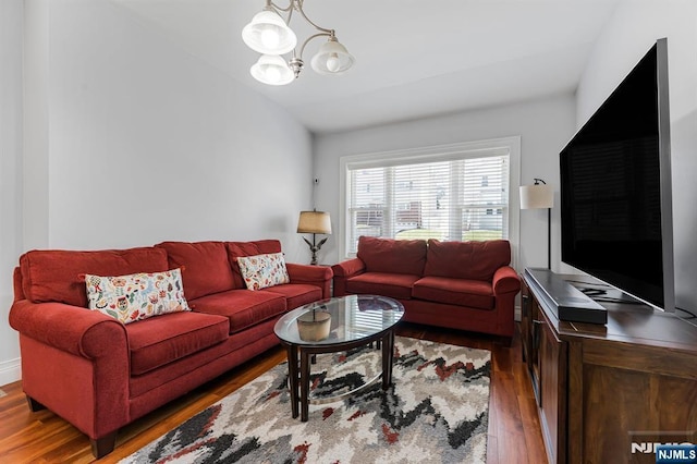 living area featuring a chandelier and wood finished floors