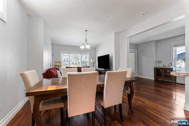 dining room with baseboards, dark wood-style floors, a chandelier, and a wealth of natural light