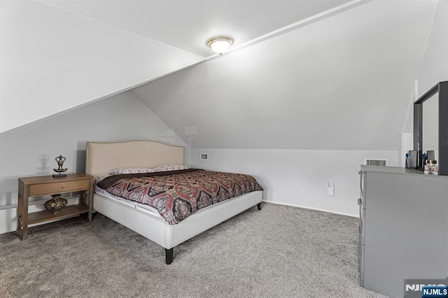 carpeted bedroom featuring vaulted ceiling