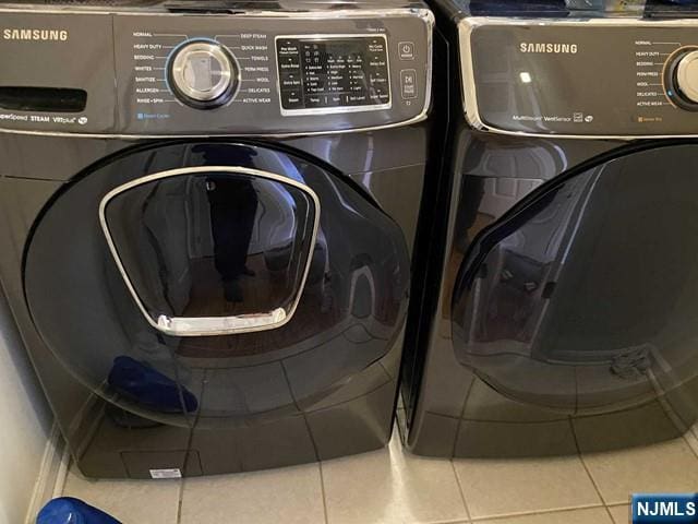 48 Legend Hills Dr, Edgewater, NJ 07020 - laundry room with tile patterned flooring, laundry area, and washer and clothes dryer