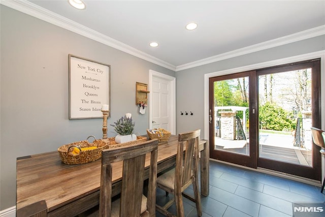 dining space featuring crown molding, dark tile patterned floors, and recessed lighting