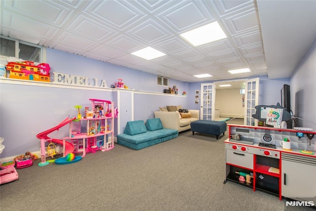 playroom with visible vents, carpet flooring, and an ornate ceiling
