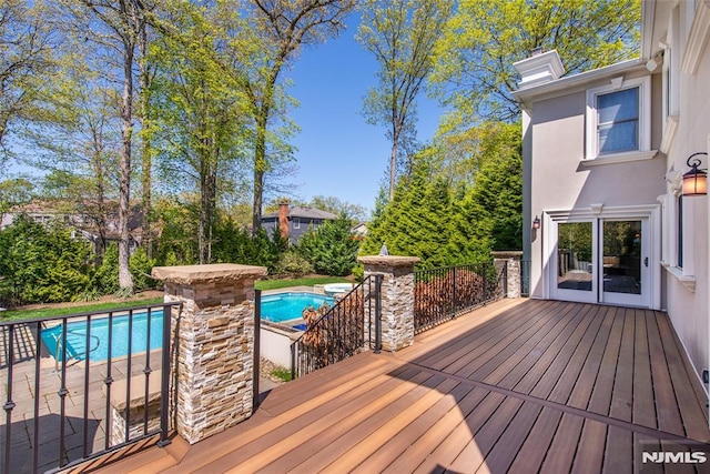 deck featuring an outdoor pool