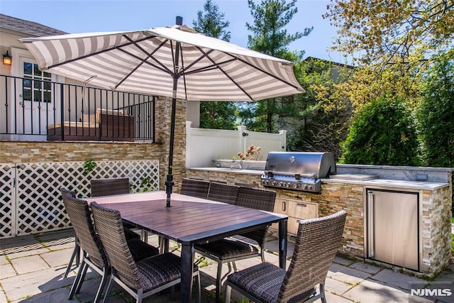 view of patio with outdoor dining area and area for grilling