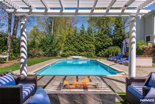 pool featuring a pergola, a fire pit, and a patio area