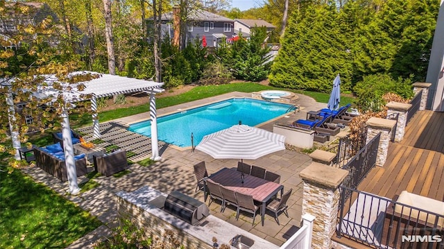 view of pool with a pool with connected hot tub, a deck, outdoor dining area, a patio, and a grill