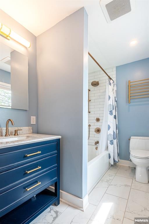 full bath with vanity, toilet, marble finish floor, baseboards, and visible vents