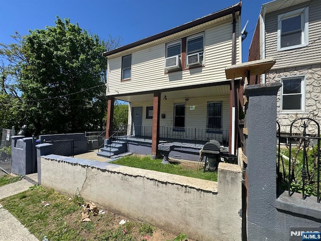 view of front facade featuring fence and a porch