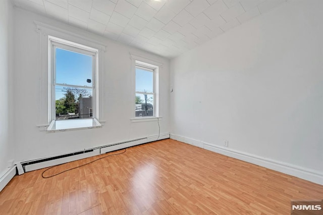 41 Heckel St, Belleville, NJ 07109 - unfurnished room featuring plenty of natural light, wood finished floors, and a baseboard radiator