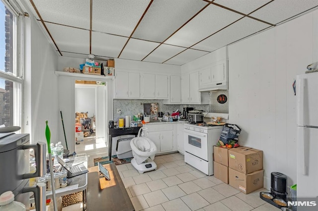 41 Heckel St, Belleville, NJ 07109 - kitchen featuring decorative backsplash, under cabinet range hood, a drop ceiling, white appliances, and white cabinetry