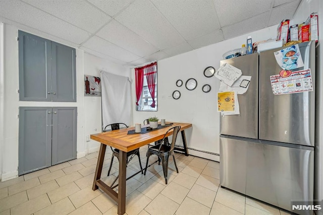41 Heckel St, Belleville, NJ 07109 - dining room with baseboard heating, baseboards, light tile patterned floors, and a paneled ceiling