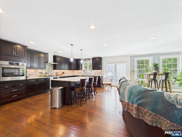 living area with dark wood finished floors and recessed lighting