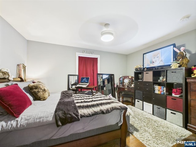 bedroom with ceiling fan and wood finished floors