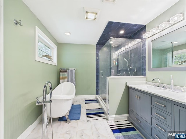 bathroom with a freestanding bath, vanity, marble finish floor, baseboards, and a shower stall