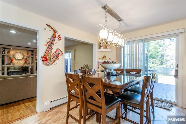 dining area featuring recessed lighting, light tile patterned floors, baseboard heating, and a wealth of natural light