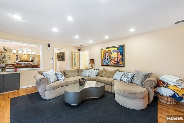 living area featuring recessed lighting, wood finished floors, and visible vents