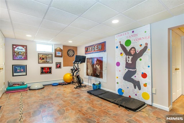 workout room with recessed lighting, baseboards, and a drop ceiling