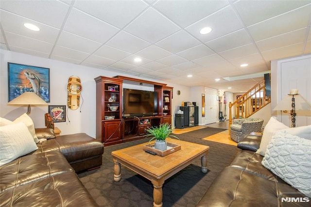 living area featuring stairway, carpet floors, recessed lighting, and a paneled ceiling