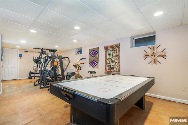 rec room with baseboards, a drop ceiling, and recessed lighting