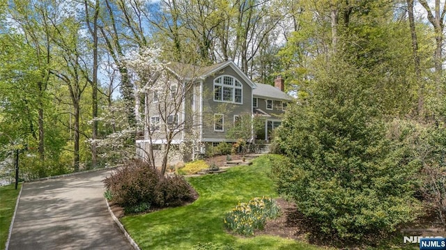exterior space with a front yard and a chimney