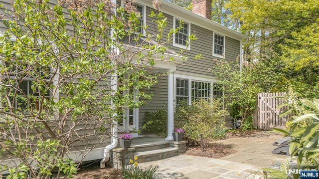 exterior space with fence and a chimney