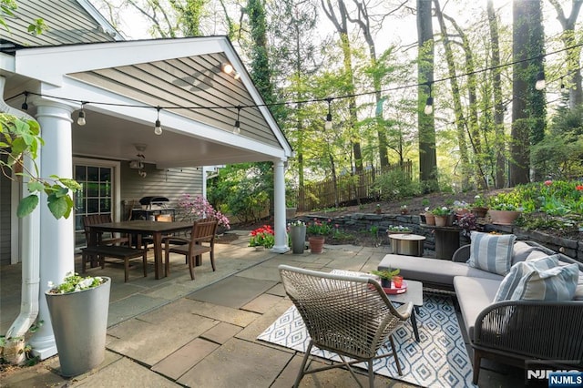 view of patio / terrace with an outdoor living space, fence, and outdoor dining space
