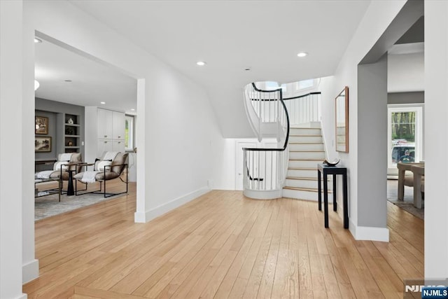 entrance foyer featuring recessed lighting, baseboards, light wood-style flooring, and stairway