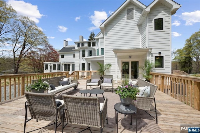 wooden terrace featuring outdoor lounge area
