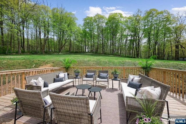 wooden deck featuring a lawn and an outdoor hangout area