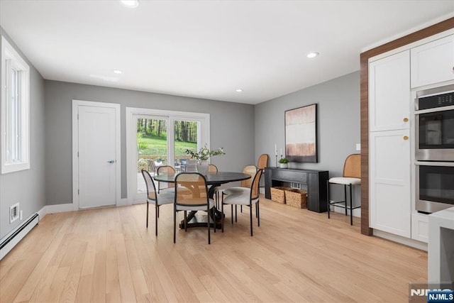 dining room featuring recessed lighting, baseboards, light wood-style flooring, and a baseboard heating unit
