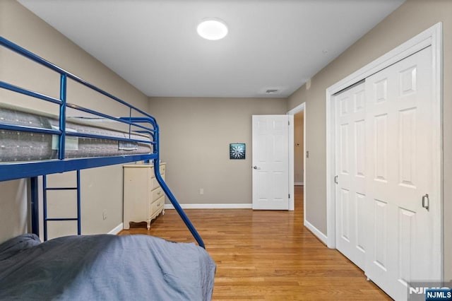 bedroom with baseboards and wood finished floors