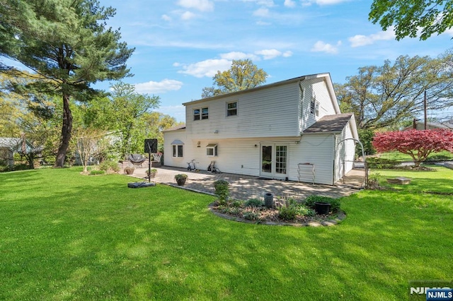 back of house featuring a lawn, french doors, and a patio area