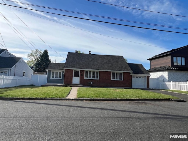 68 Echo Pl, Elmwood Park, NJ 07407 - view of front facade with fence, brick siding, a garage, a front yard, and driveway