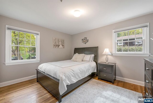 bedroom featuring baseboards and wood finished floors