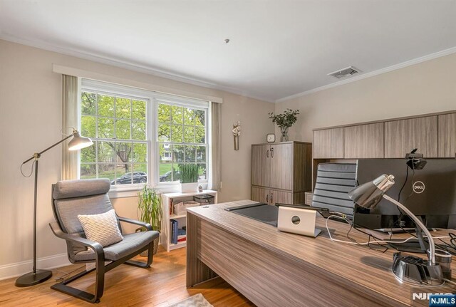 office with crown molding, baseboards, light wood-style flooring, and visible vents