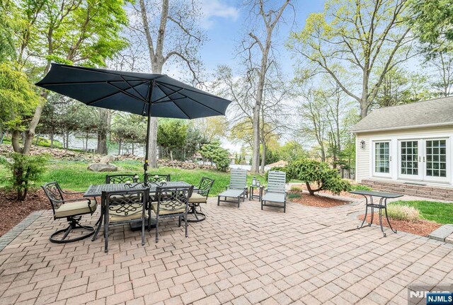 view of patio with outdoor dining area and french doors