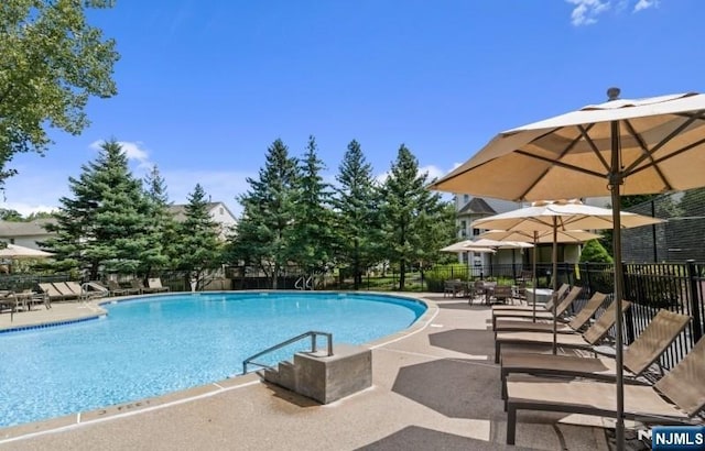 pool with fence and a patio area
