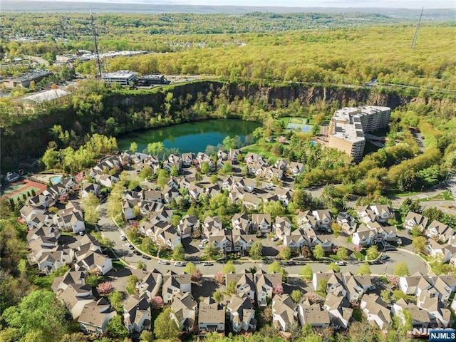 birds eye view of property with a water view, a residential view, and a forest view