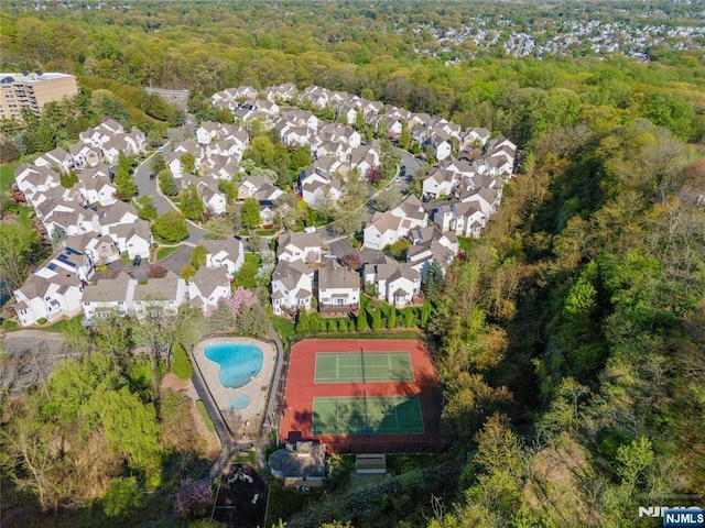 birds eye view of property featuring a view of trees