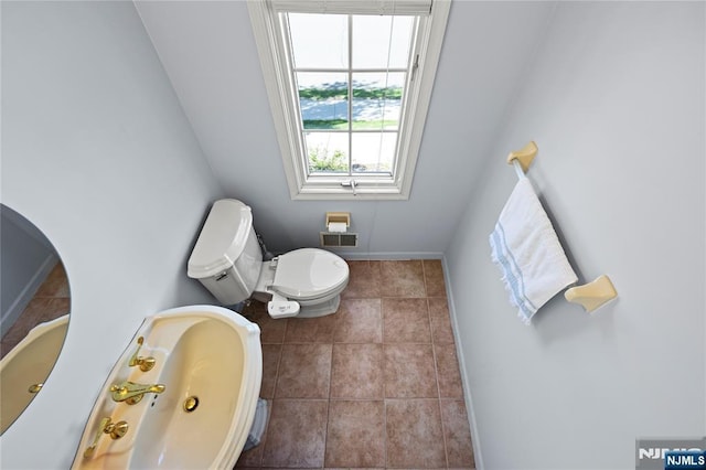 half bath with toilet, tile patterned floors, visible vents, and baseboards