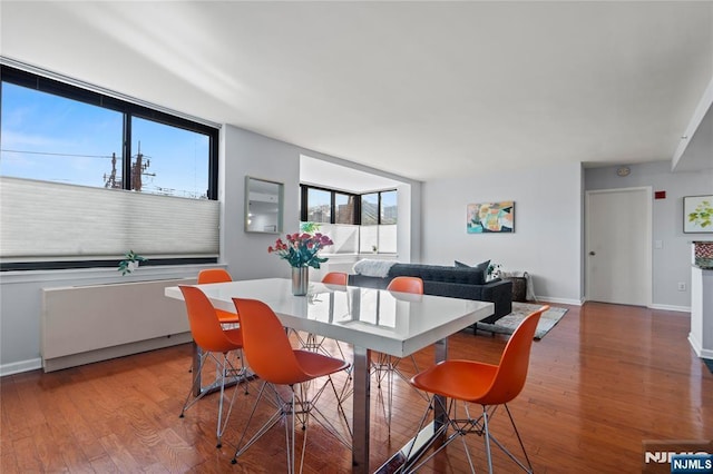 dining area featuring baseboards and wood finished floors