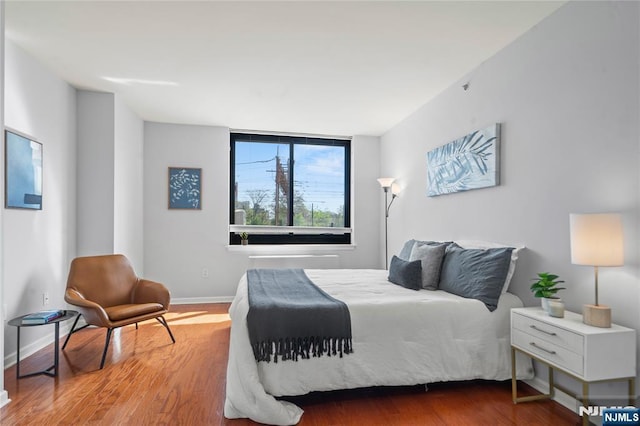 bedroom featuring baseboards and wood finished floors